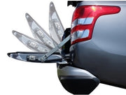 Car safety reflector attached to a vehicle's rear, showing multiple reflective surfaces.